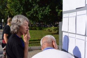 Jill Steen standing at a notice board, checking where her name is in her Kung Fu competition category.